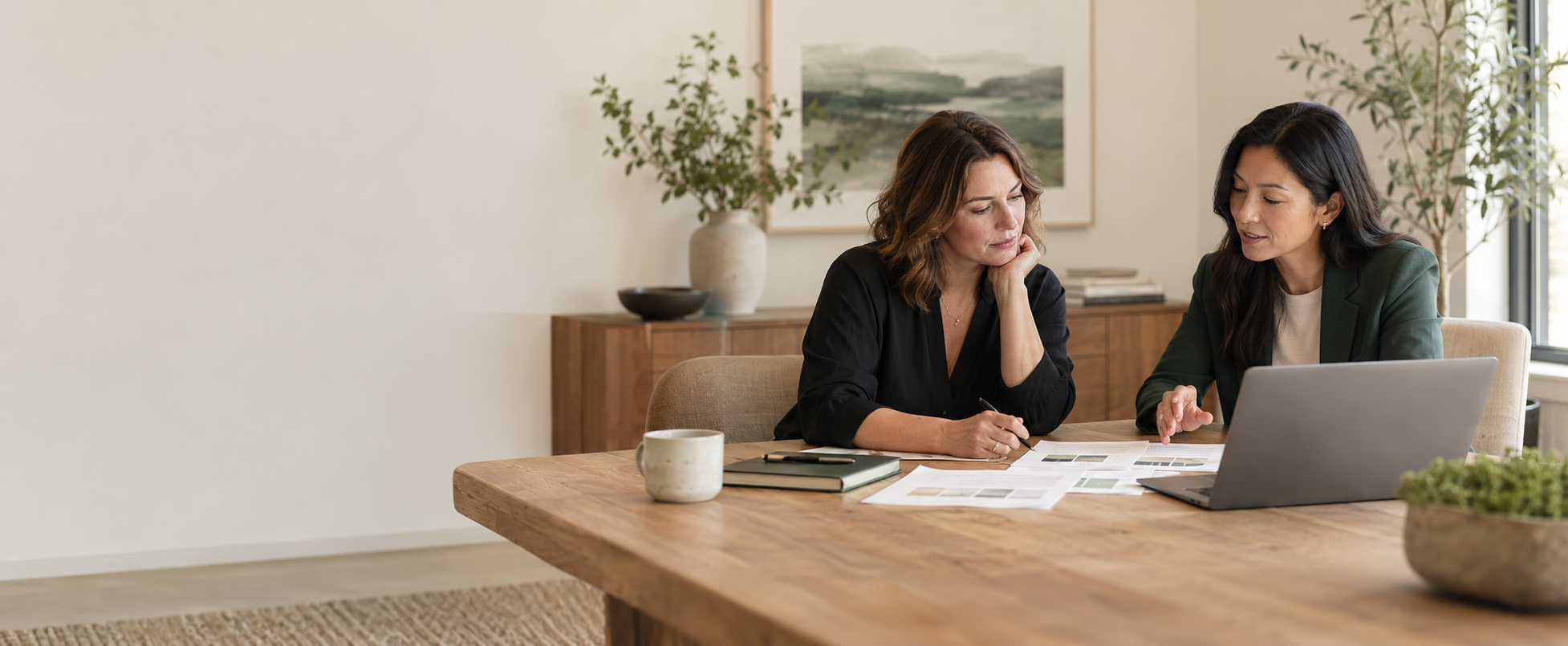A business owner and strategist thoughtfully reviewing business information together